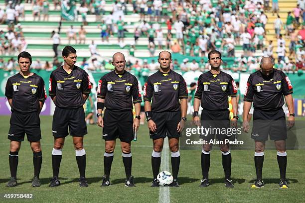 Referees enter into the field before a match between Chapecoense and Cruzeiro for the Brazilian Series A 2014 at Arena Conda Stadium on November 30,...