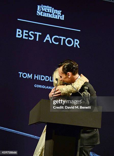 Dame Helen Mirren congratulates Best Actor winner Tom Hiddleston onstage at the 60th London Evening Standard Theatre Awards at the London Palladium...