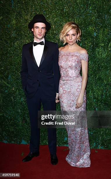 Tom Sturridge and Sienna Miller attends the 60th London Evening Standard Theatre Awards at London Palladium on November 30, 2014 in London, England.
