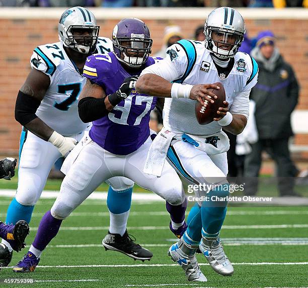 Carolina Panthers quarterback Cam Newton scrambles for yardage as Minnesota Vikings defensive end Everson Griffen gives chase during second quarter...