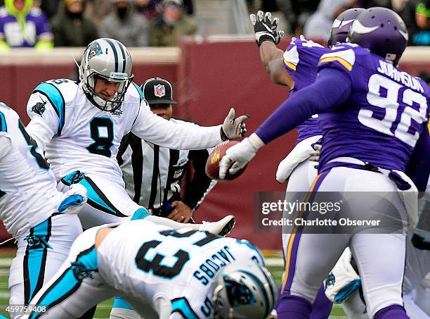 Carolina Panthers punter Brad Nortman has a second punt blocked by Minnesota Vikings linebacker Jasper Brinkley during second quarter action on...