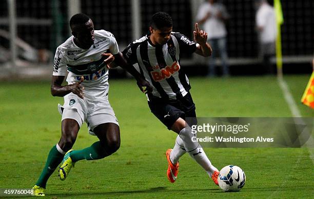 Douglas Santos of Atletico MG struggles for the ball with Joel Tadjo of Coritiba during a match between Atletico MG and Coritiba as part of...