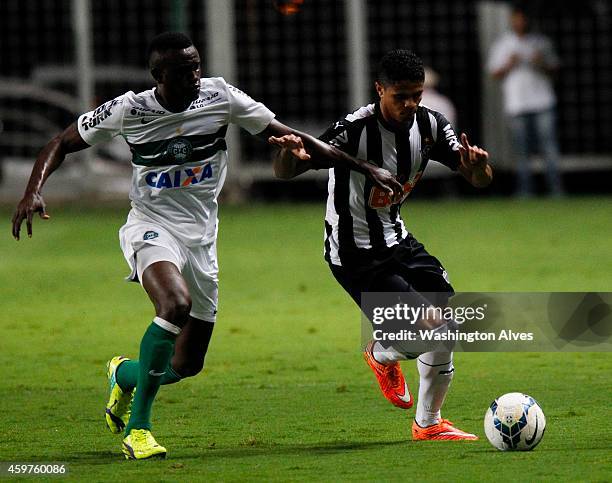 Douglas Santos of Atletico MG struggles for the ball with Joel Tadjo of Coritiba during a match between Atletico MG and Coritiba as part of...