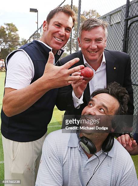 Australian cricket legend Shane Warne poses with Triple M radio hosts Mick Molloy and Eddie McGuire and after injuring a finger when bowling in the...