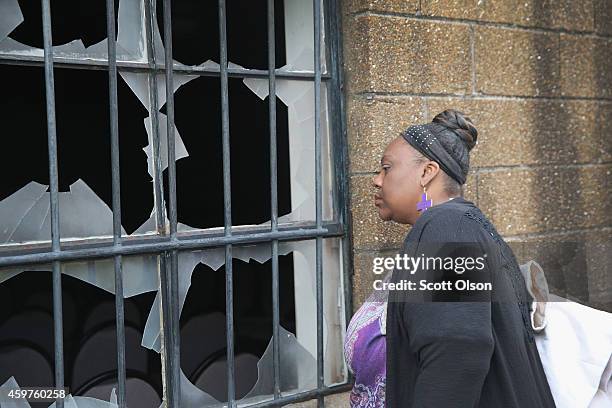 Shanteau Wharton looks in a window of the fire-damaged Flood Christian Church on November 30, 2014 in Ferguson, Missouri. Michael Brown, the Father...