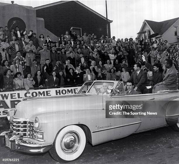 Larry Doby and his wife Helyn wave to cheering Eastside High School students who were given half a day off from school studies to help celebrate...