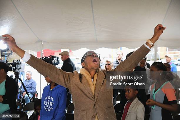 Members of the fire-damaged Flood Christian Church attend Sunday service in a tent in a nearby parking lot on November 30, 2014 in Ferguson,...