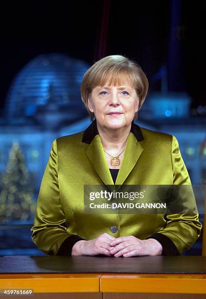 German Chancellor Angela Merkel poses for a photograph after the recording of her annual New Year's speech at the Chancellery in Berlin on December...