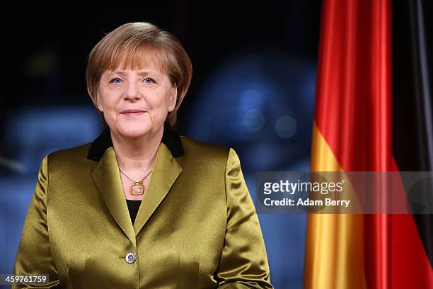 German Chancellor Angela Merkel poses moments after giving her New Year's television address to the nation at the federal chancellery on December 30,...