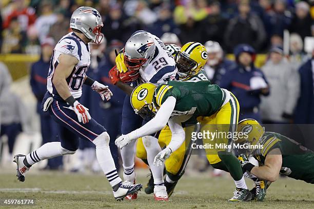 Nose tackle Letroy Guion of the Green Bay Packers tackles running back LeGarrette Blount of the New England Patriots in the second half of the NFL...