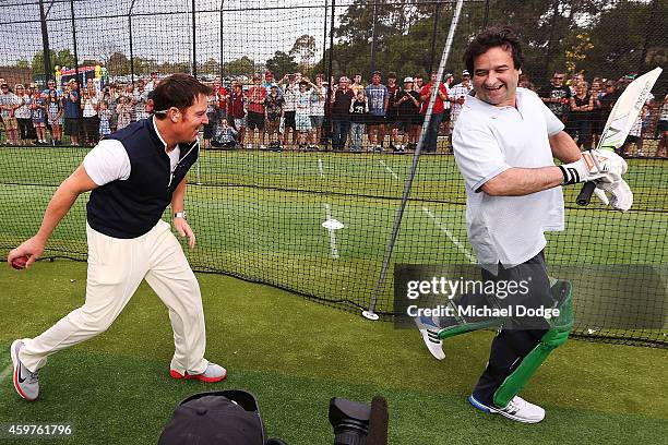 Triple M radio host Mick Molloy reacts as Australian cricket legend Shane Warne looks to through a ball into his backside in the nets during the Luke...