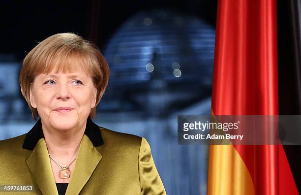 German Chancellor Angela Merkel poses moments after giving her New Year's television address to the nation at the federal chancellery on December 30,...