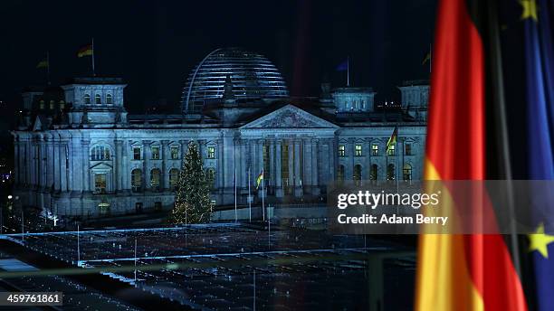 The Reichstag building is seen out of a television studio window prior to the recording of German Chancellor Angela Merkel's New Year's television...