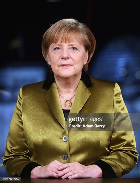 German Chancellor Angela Merkel poses moments after giving her New Year's television address to the nation at the federal chancellery on December 30,...