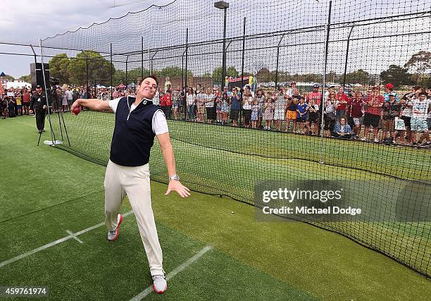 Australian cricket legend Shane Warne bowls to Triple M radio host Mick Molloy in the nets during the Luke Batty Memorial at Tyabb Football Netball...