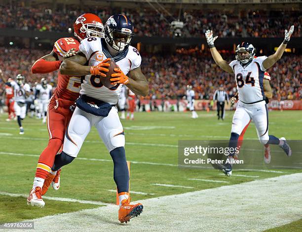 Demaryius Thomas of the Denver Broncos scores a touchdown against Sean Smith of the Kansas City Chiefs during the first quarter at Arrowhead Stadium...