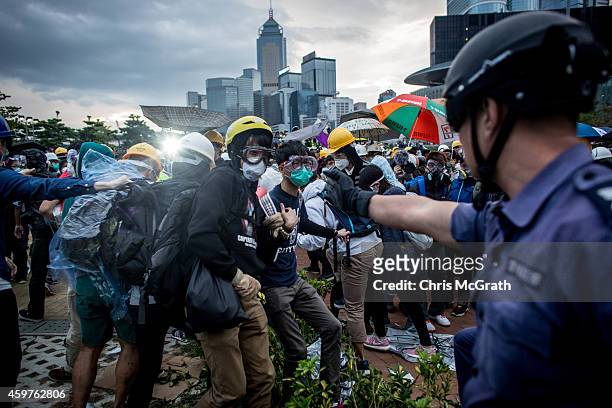 Pro-democracy protesters clash with police outside Hong Kong's Government complex on December 1, 2014 in Hong Kong. Leaders from the Federation of...