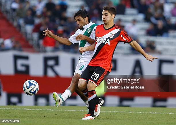 Ezequiel Cirigliano of River Plate fights for the ball with Walter Erviti of Banfield during a match between Banfield and River Plate as part of...