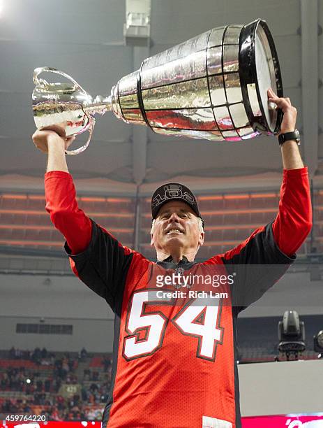Head coach John Hufnagel of the Calgary Stampeders lifts up the Grey Cup after defeating the Hamilton Tiger-Cats to win the 102nd Grey Cup...