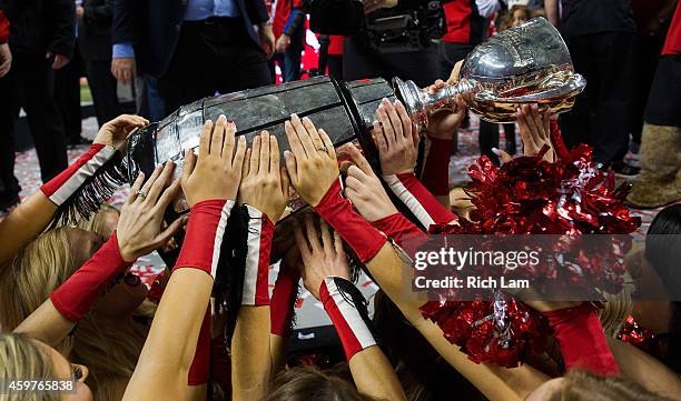 The Calgary Stampeders cheerleaders are presented with the Grey Cup after the Calgary Stampeders defeated the Hamilton Tiger-Cats in the 102nd Grey...