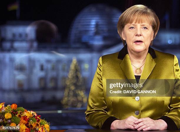 German Chancellor Angela Merkel poses for a photograph after the recording of her annual New Year's speech at the Chancellery in Berlin on December...