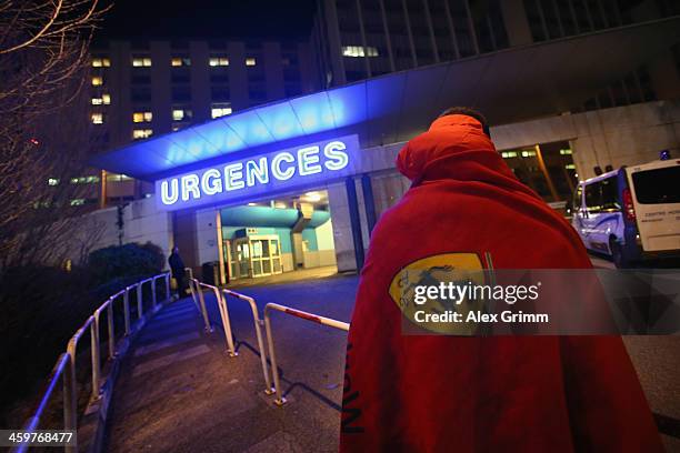 Ferrari fan waits in front of the emergency hospitalisation of Grenoble Hospital where former German Formula One driver Michael Schumacher is being...