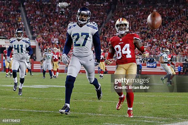 Wide receiver Brandon Lloyd of the San Francisco 49ers is unable to get to an overthrown pass against cornerback Tharold Simon of the Seattle...