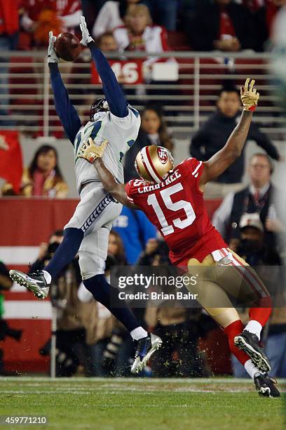 Cornerback Tharold Simon of the Seattle Seahawks tries to get his hands on a pass against wide receiver Michael Crabtree of the San Francisco 49ers...