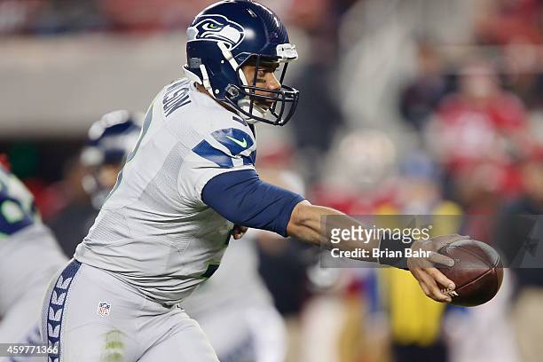 Russell Wilson of the Seattle Seahawks hands the ball off against the San Francisco 49ers in the fourth quarter on November 27, 2014 at Levi's...