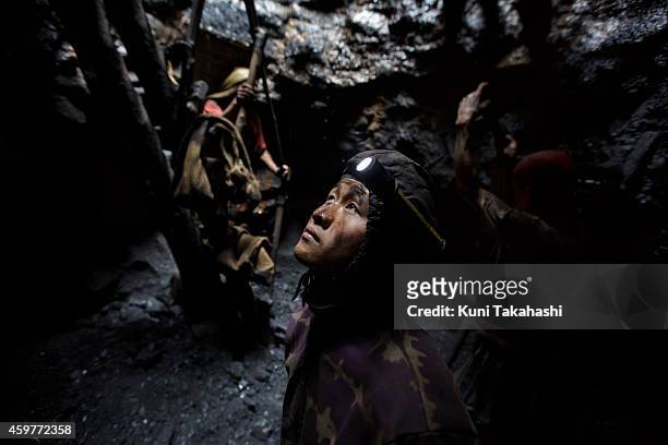 Young migrant coal miner from Nepal looks up from a mine hole in Jaintia Hills, Meghalaya in India on April 30, 2014. Indian government announced in...