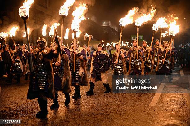 Men dressed as Vikings take part in the torchlight procession as it makes its way through Edinburgh for the start of the Hogmanay celebrations on...