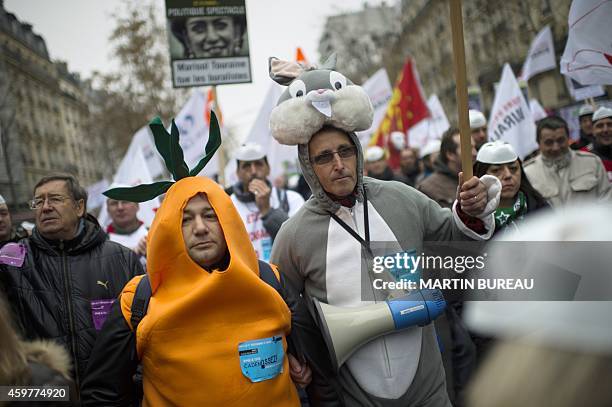 Business owners wearing a rabbit and carrot costume march in Paris during a protest against hefty taxes, charges and stifling regulations they say...