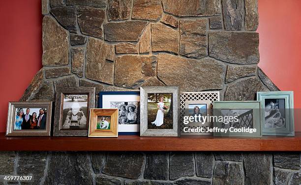 family photos on mantle large group - mantelpiece stock pictures, royalty-free photos & images