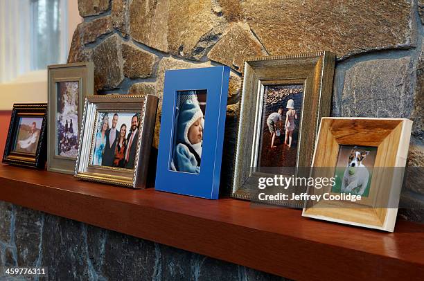 family photos on mantle angled - photo frame on mantle piece stock pictures, royalty-free photos & images