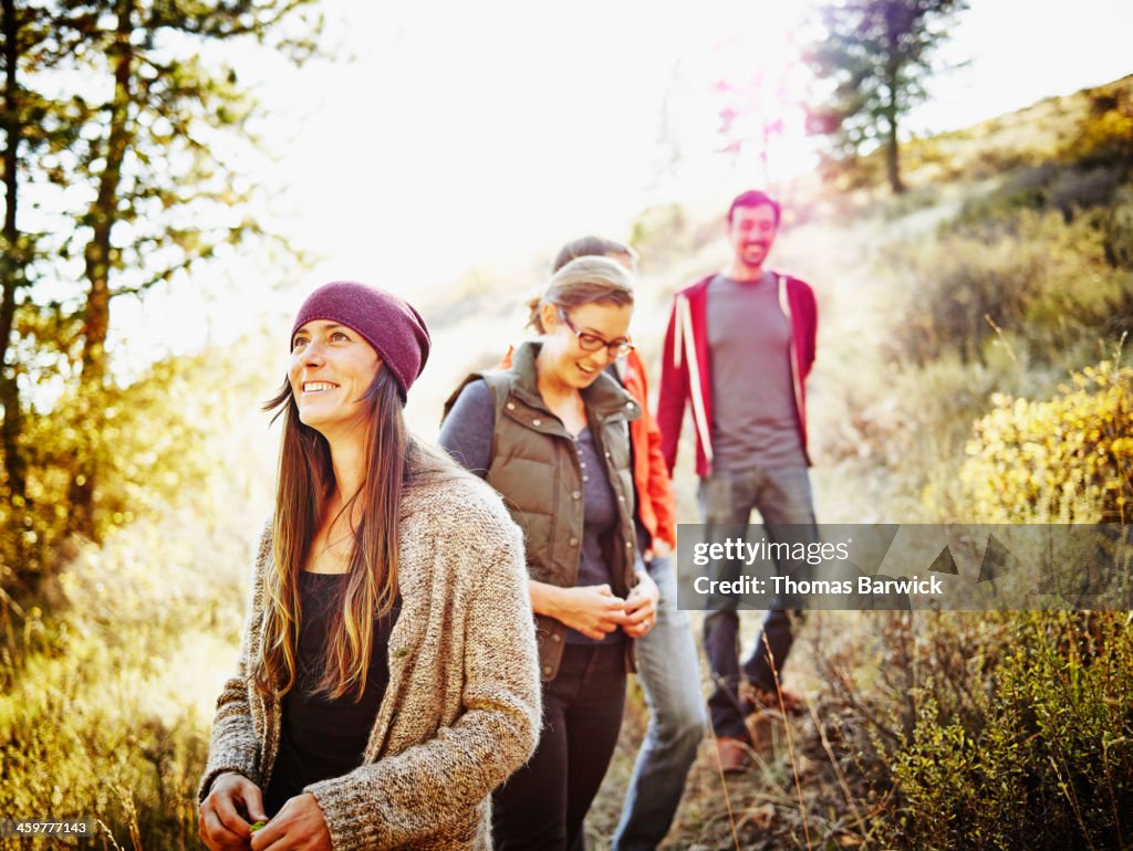 Laughing group of friends hiking on hillside