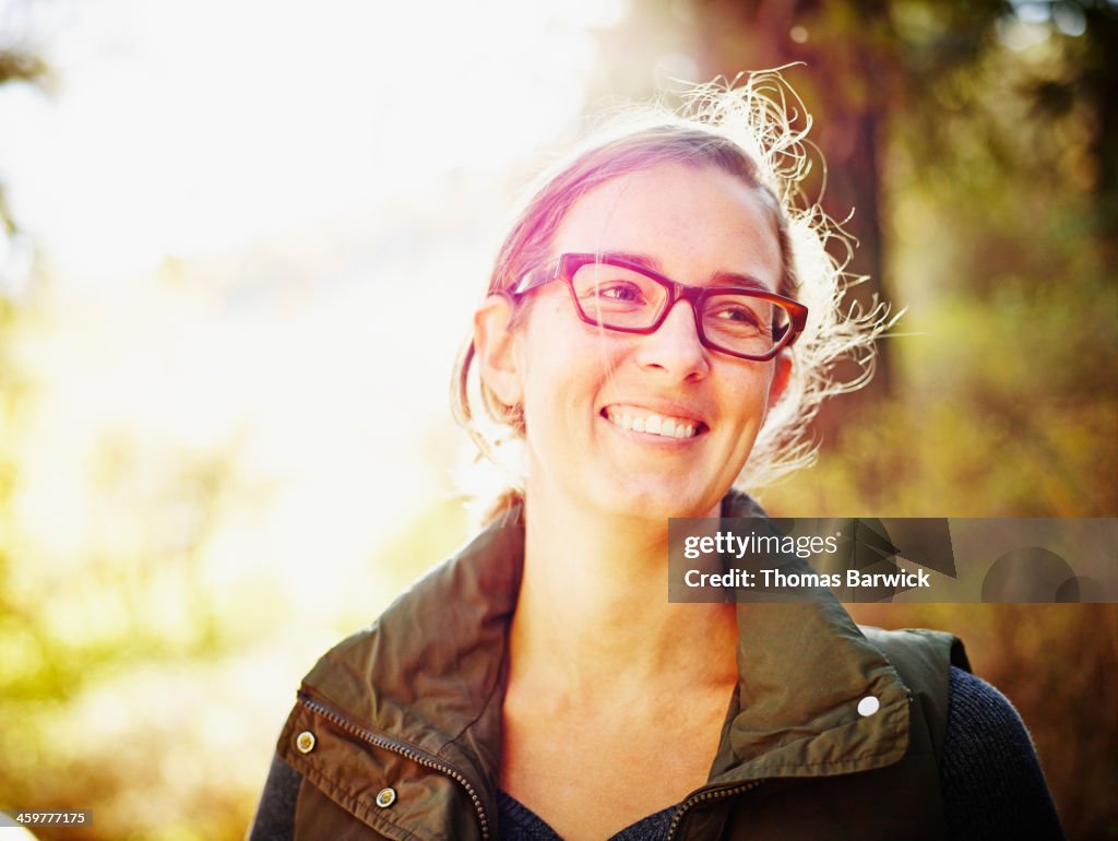 Smiling woman standing outdoors in forest