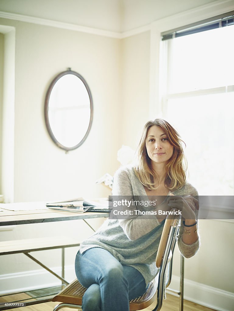 Woman sitting in chair in home