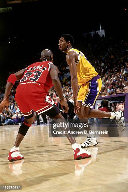 Kobe Bryant of the Los Angeles Lakers drives against Michael Jordan of the Chicago Bulls on February 1, 1998 at The Forum in Inglewood, California....