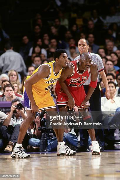 Kobe Bryant of the Los Angeles Lakers defends against Michael Jordan of the Chicago Bulls on February 1, 1998 at The Forum in Inglewood, California....