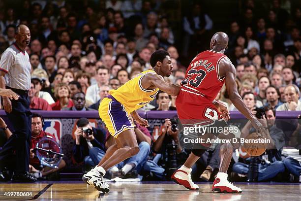 Kobe Bryant of the Los Angeles Lakers defends against Michael Jordan of the Chicago Bulls on February 1, 1998 at The Forum in Inglewood, California....