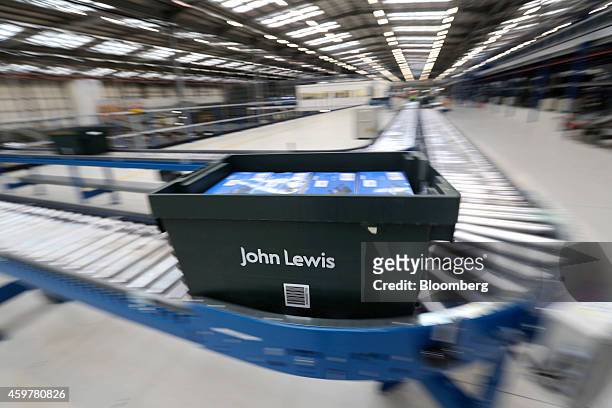 Branded John Lewis crate transports goods for processing into customer orders at the John Lewis Plc semi-automated distribution centre in Milton...