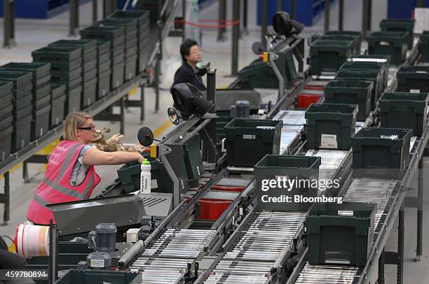 Workers sort customer "click and collect" orders into crates destined for John Lewis stores, at the John Lewis Plc semi-automated distribution centre...