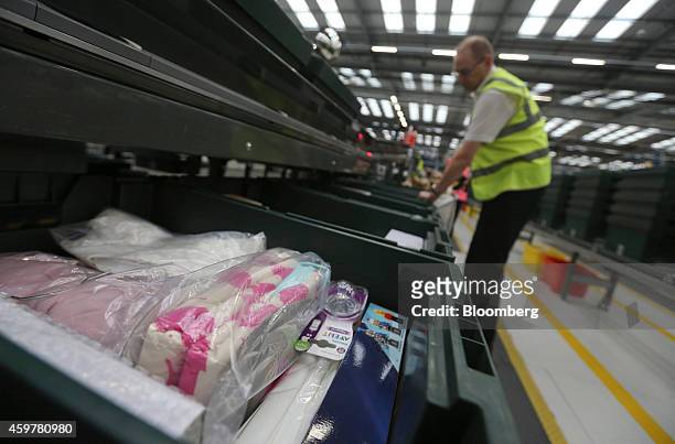 Worker sorts customer "click and collect" orders into crates destined for John Lewis stores, at the John Lewis Plc semi-automated distribution centre...
