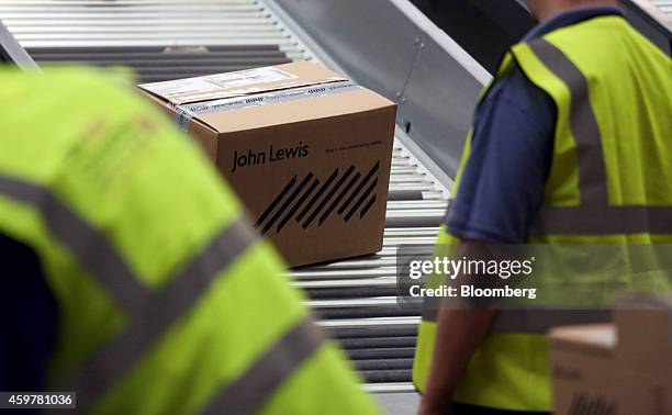 Packed customer order travels along a conveyor belt ahead of shipping from the John Lewis Plc semi-automated distribution centre in Milton Keynes,...