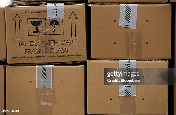 Boxed customer orders sit stacked on a pallet ahead of shipping from the John Lewis Plc semi-automated distribution centre in Milton Keynes, U.K., on...