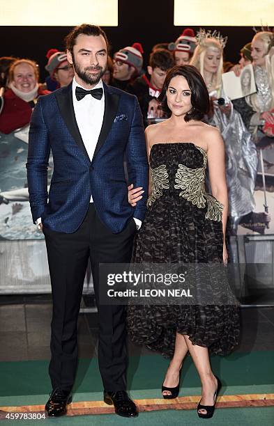 Irish actor Aidan Turner and his partner Sarah Greene pose for pictures on the red carpet upon arrival for the world premier of "The Hobbit: The...