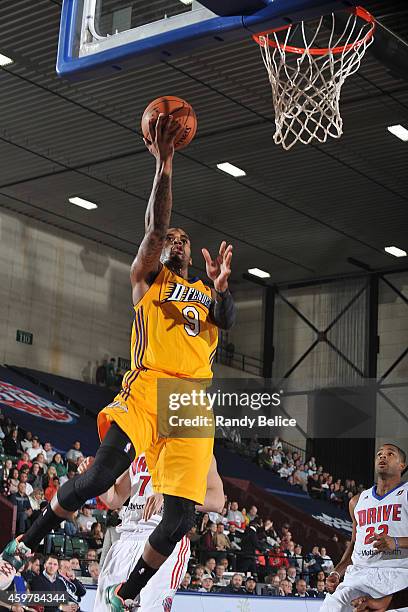 Vander Blue of the Los Angeles D-Fenders goes to the basket past Josh Bostic of the Grand Rapids Drive during the NBA D-League game on November 26,...
