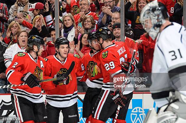 Duncan Keith, Andrew Shaw, Brandon Saad and Bryan Bickell of the Chicago Blackhawks celebrate after Saad scored in the first period, as goalie Martin...