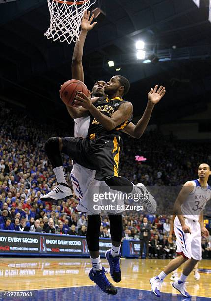 Julius Brown of the Toledo Rockets drives to the goal against Joel Embiid of the Kansas Jayhawks in the second half at Allen Fieldhouse on December...