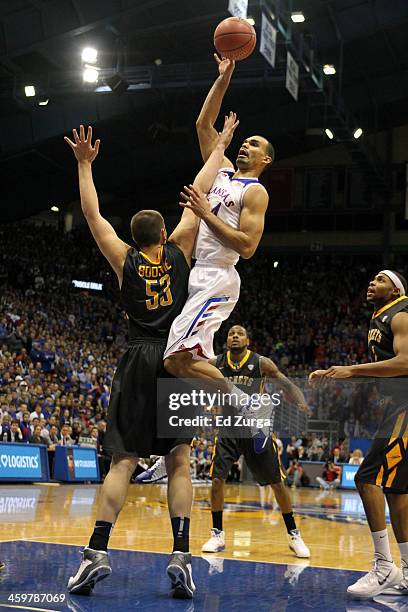 Perry Ellis of the Kansas Jayhawks shoots over Nathan Boothe of the Toledo Rockets at Allen Fieldhouse on December 30, 2013 in Lawrence, Kansas.